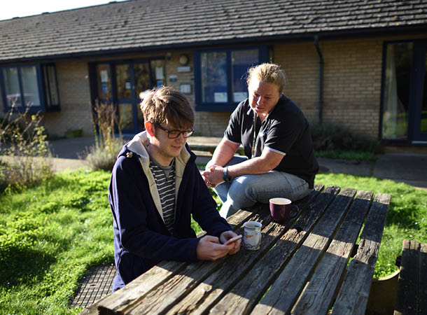 Support housing staff with resident in the garden