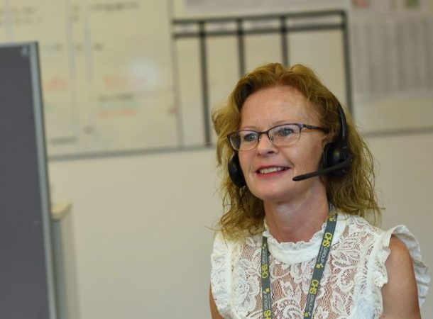Smiling CHS customer Service advisor talking to customers on the phone