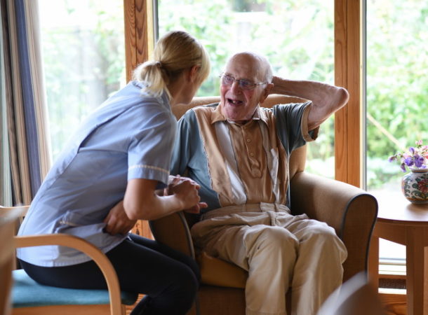 care home staff interacting with elderly resident