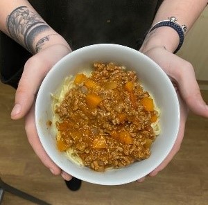 Resident with bowl of spaghetti Bolognese