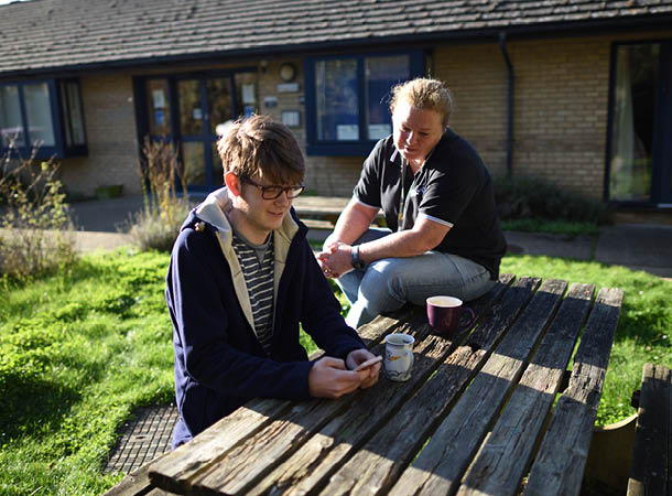 Support housing staff with resident in the garden