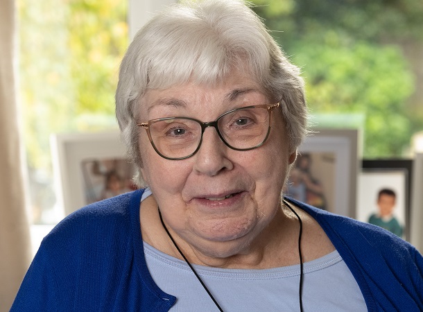 Older white female tenant wearing emergency pendant