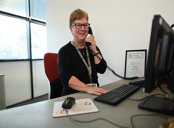 White female CHS receptionist speaking on the phone