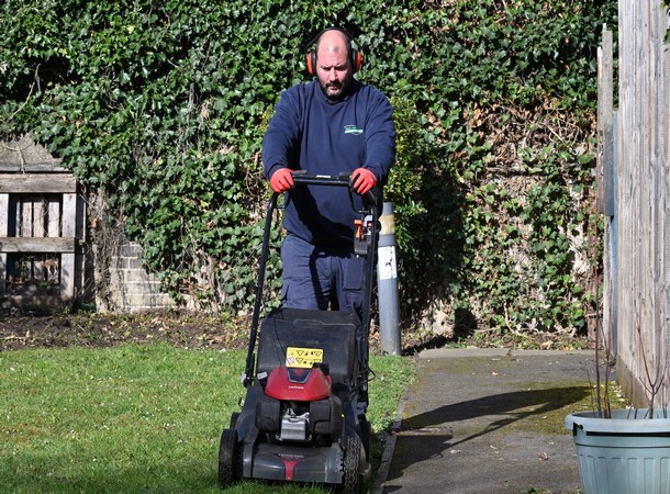 Photo of Mark Walker gardeners mowing the lawn