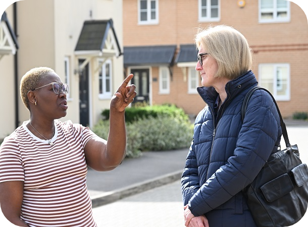 CHS staff talking to tenant outside their home